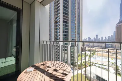 a balcony with a table and a view of a city at Dubai Mall Connected! AMAZING Burj Khalifa View! Excellent Pool & Gym Access! in Dubai