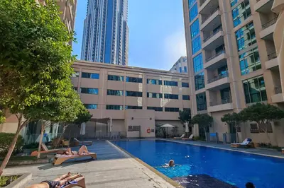 a group of people laying in a swimming pool in a building at Stylish 1-BR Oasis Minutes from Burj & Dubai Mall in Dubai