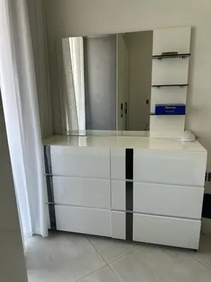 a dressing room with white dressers and a mirror at Close to burj khalifa nice place in Dubai