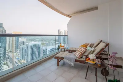 a living room with a view of a city at Frank Porter - Time Place Tower in Dubai