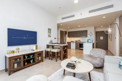 a living room with a couch and a table at Near Burj Khalifa & Dubai Mall - 1BR in Grande Residence, Downtown - Allsopp & Allsopp in Dubai