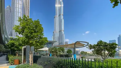 a view of a city skyline with a tall skyscraper at Near Burj Khalifa & Dubai Mall - 1BR in Grande Residence, Downtown - Allsopp & Allsopp in Dubai