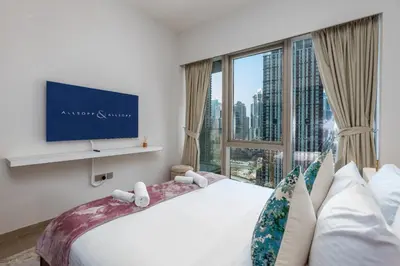 a bedroom with a bed and a large window at Near Burj Khalifa & Dubai Mall - 1BR in Grande Residence, Downtown - Allsopp & Allsopp in Dubai