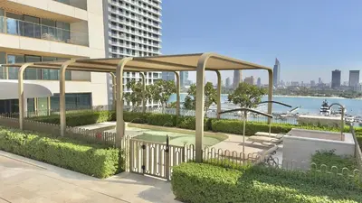 a pavilion in front of a building next to a park at Guest Favorite 1BR Designer Apt with Beach Access by Vibel in Dubai