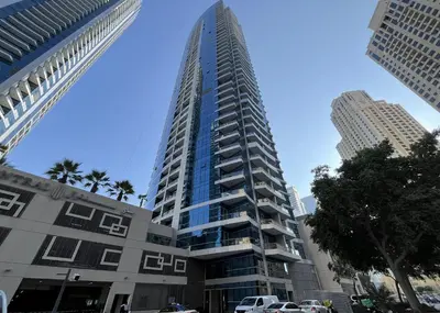 a tall building with cars parked in front of it at Stunning 1 bedroom in JBR with Balcony - Dubai Marina Mall view in Dubai