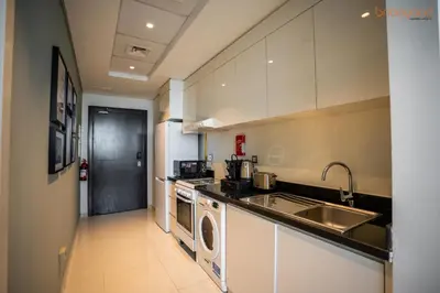 a kitchen with a sink and a dishwasher at Quirky Studio Apartment in Damac Ghalia in Dubai
