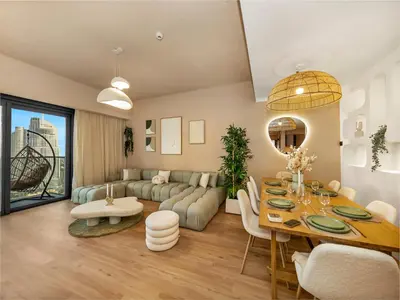 a living room with a table and a couch at Wabi-Sabi Style Fountain-View 4 BR Apt in the Sky in Dubai