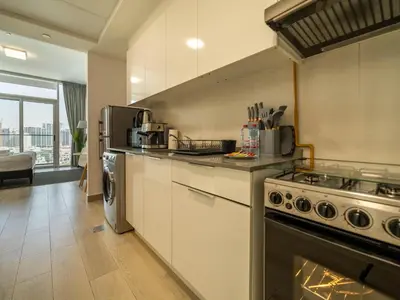a kitchen with a stove and a stove top oven at Brand New Premium Studio In JVC in Dubai