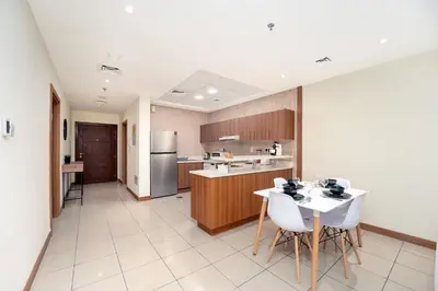 a kitchen with a table and chairs in a room at Spacious Upgraded & Elegant - 1BR in Dubai