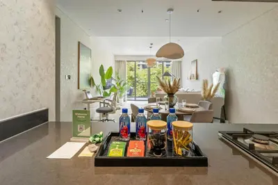 a tray with drinks on a counter in a kitchen at Spacious 1BR with Pool, Gym & Kids Play Area in Dubai
