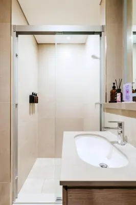 a bathroom with a sink and a shower at New Cosy 1BR with Pool & Gym in City Centre in Dubai