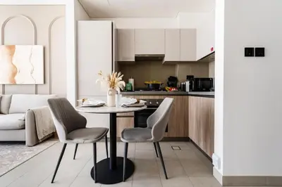 a kitchen with a table and chairs in a room at New Cosy 1BR with Pool & Gym in City Centre in Dubai