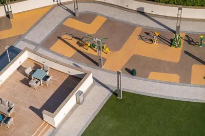 an overhead view of a building with a playground at New Cosy 1BR with Pool & Gym in City Centre in Dubai