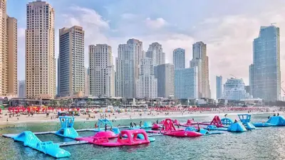 a group of inflatables in the water at a beach at 2BR Marina View - Beach Access - Sleeps 8 in JBR in Dubai