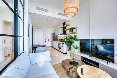 a living room with a couch and a table at Collective Tower, Dubai Hills Estate in Dubai