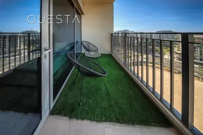 a balcony with a chair and a table at Park Heights 1 by Emaar, Dubai Hills Estate in Dubai