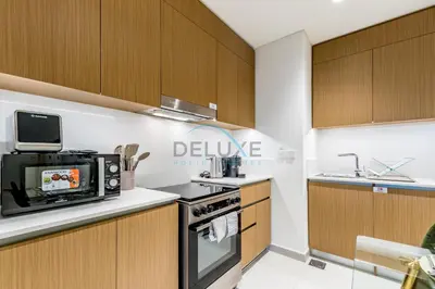 a kitchen with a stove and a microwave at Bright 2BR in Surf at Creek Beach Building 1, Creek Harbour by Deluxe Holiday Homes in Dubai