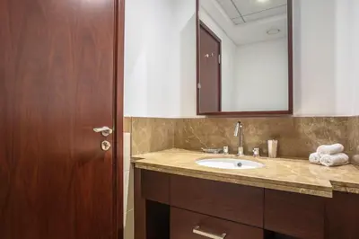 a bathroom with a sink and a mirror at Vacay lettings 1 bed close to down town Fountain View in Dubai