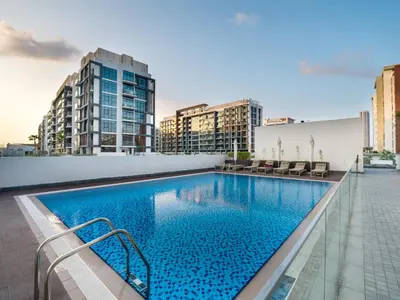 a swimming pool on top of a building with buildings at EasyGo - Bright and Airy Studio in Azizi Riviera 9 in Dubai