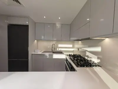 a kitchen with white cabinets and a stove at 2 Bedroom beach front apartment in Dubai