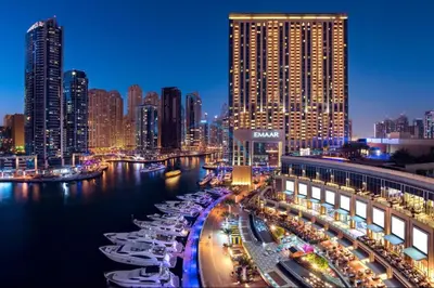 a view of a city at night with boats in the water at Lovely Studio in The Address Residence Dubai Marina by Deluxe Holiday Homes in Dubai