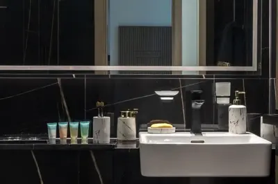 a bathroom with a white sink and a mirror at Casa Azure in Dubai