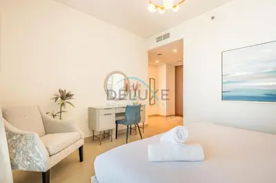 a bedroom with a bed and a chair and a desk at Sea View 3BR with Assistant Room and Balcony, Just Steps from Marina Promenade, 5242 Tower 1, Dubai Marina by Deluxe Holiday Homes in Dubai