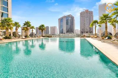 a large swimming pool in the middle of a city at Keysplease 1BR Apartment Damac Maison Prive Business Bay in Dubai
