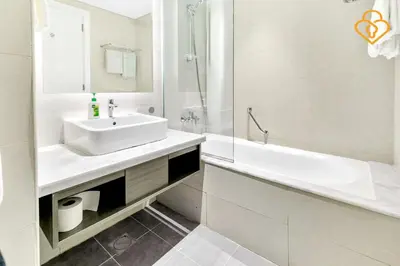 a white bathroom with a sink and a bath tub at Keysplease 1BR Apartment Damac Maison Prive Business Bay in Dubai