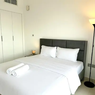 a bedroom with a bed with two towels on it at Dezire Delight in Dubai