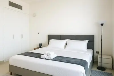 a bedroom with a bed with two towels on it at Dezire Delight in Dubai