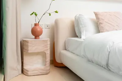 a bedroom with a couch and a vase on a side table at Apartment on Palm Jumeirah Beach Parking in Dubai