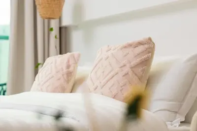 a white couch with two pillows on it at Apartment on Palm Jumeirah Beach Parking in Dubai