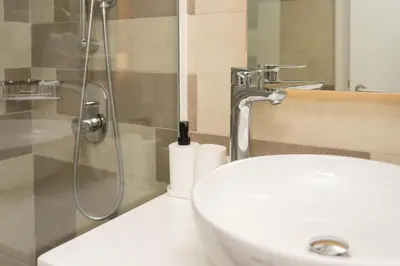 a bathroom with a sink and a shower and a toilet at Apartment on Palm Jumeirah Beach Parking in Dubai