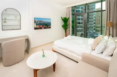 a white living room with a couch and a table at Apartment on Palm Jumeirah Beach Parking in Dubai