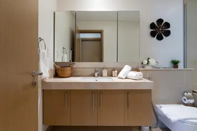 a bathroom with a sink and a mirror at Cozy and Stunning Waterfront One Bed in Dubai