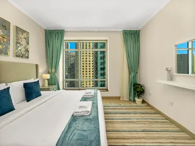a bedroom with a large bed with a large window at Prime Location - Amazing Burj Khalifa View in Dubai