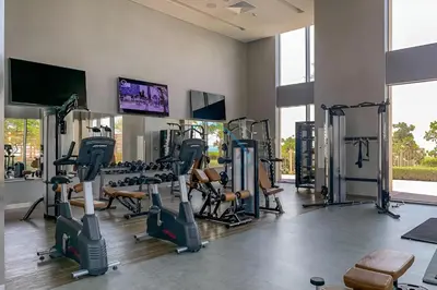 a gym with treadmills and tread machines in a room at Elegant 1BR in 5242 Tower 1, Dubai Marina by Deluxe Holiday Homes in Dubai