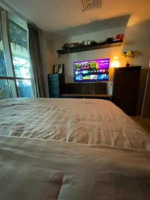 a bedroom with a large bed and a tv at Fully upgraded luxurious one bedroom between Marina and JBR in Dubai