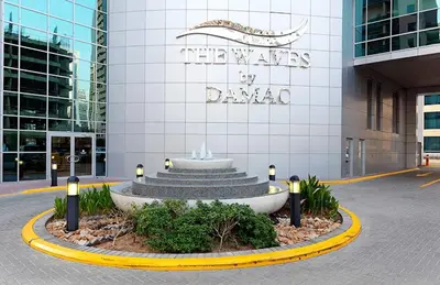 a building with a fountain in front of a building at Fully upgraded luxurious one bedroom between Marina and JBR in Dubai