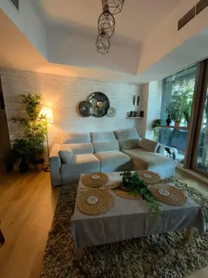 a living room with a couch and a table at Fully upgraded luxurious one bedroom between Marina and JBR in Dubai