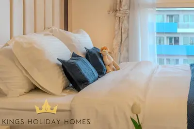 a stuffed animal sitting on top of a bed at Luxury 2 Apartments Dunya tower Burj Khalifa St in Dubai