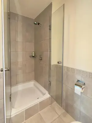 a bathroom with a shower with a white tub at Modern Apartment in Dubai Marina in Dubai