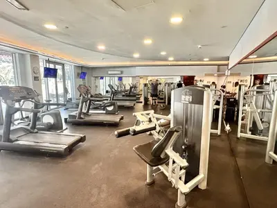 a gym with several treadms and machines in a room at Modern Apartment in Dubai Marina in Dubai