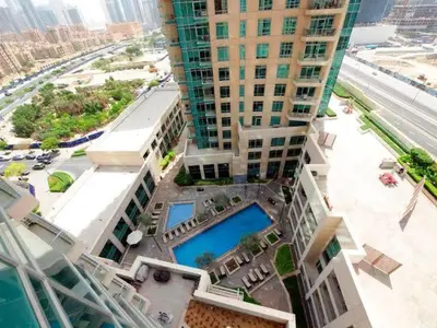 an aerial view of a building with two pools at 2BR Luxury Apartment in Downtown Opposite Mall and Fountain Entrance in Dubai