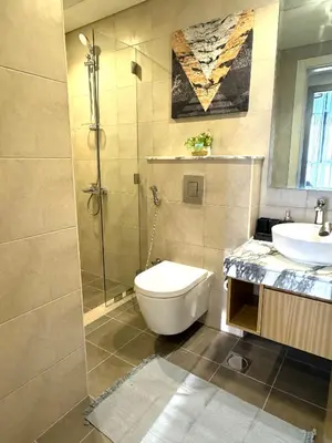 a bathroom with a shower and a toilet and a sink at Samani vacation homes 3018 in Dubai