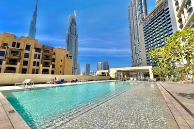 a swimming pool in a city with tall buildings at Urban Zen Sky Suite 1BR - Dubai Mall Access by Maxx Value homes in Dubai