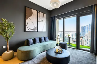 a living room with a couch and a large window at Urban Zen Sky Suite 1BR - Dubai Mall Access by Maxx Value homes in Dubai