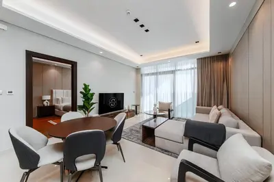 a living room with a couch and a table and chairs at 10 Mins to Dubai Mall1BRBusiness Bay Heaven in Dubai