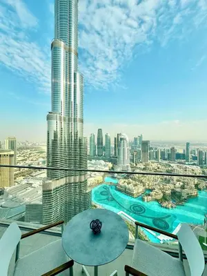 a balcony with a table and a view of a city at ADDRESS Residences Dubai Opera at Downtown in Dubai